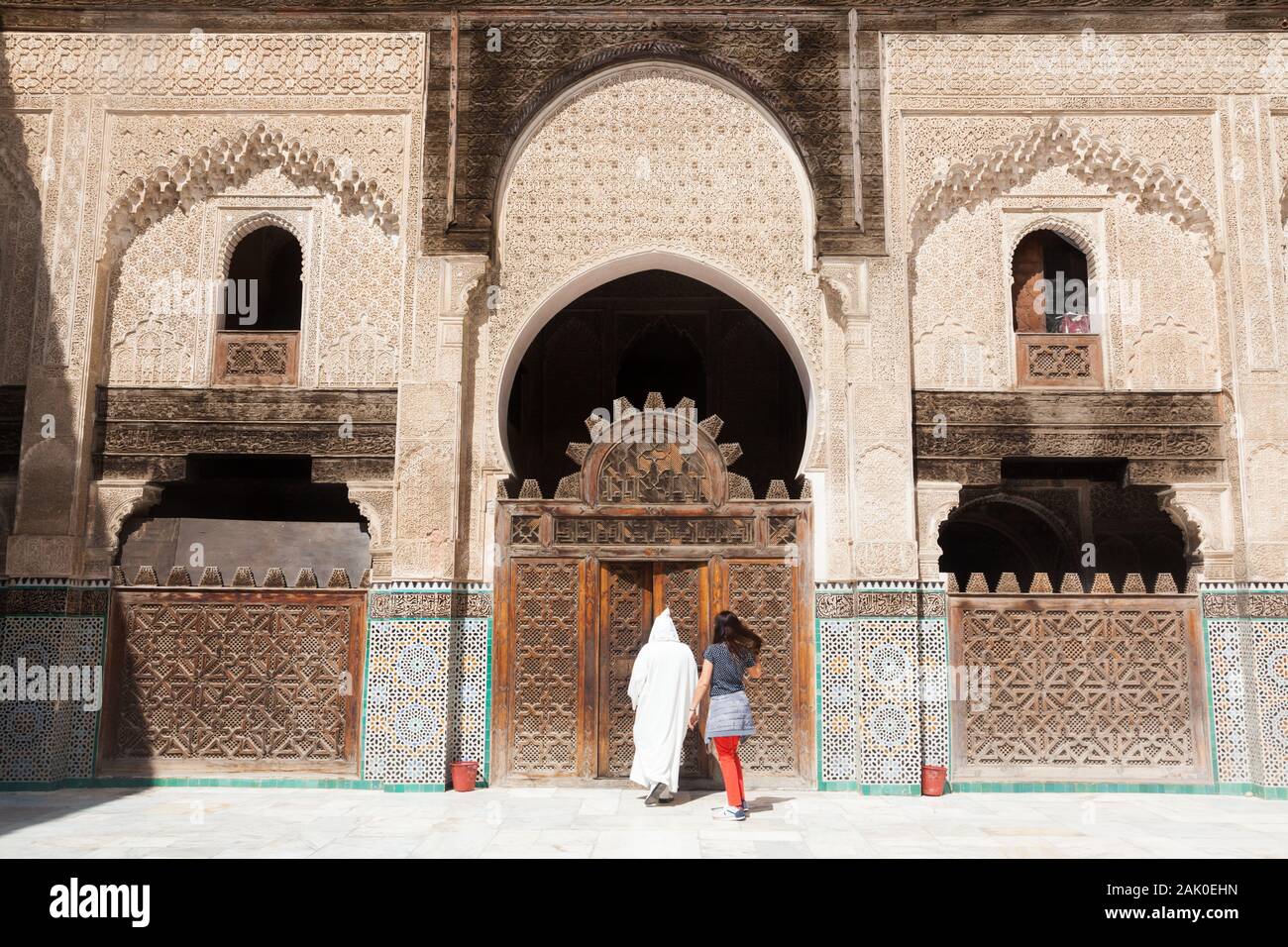 Zwei Personen, die den Hof von Bou Inania Madrasa in Fes (Fez), Marokko, verlassen Stockfoto