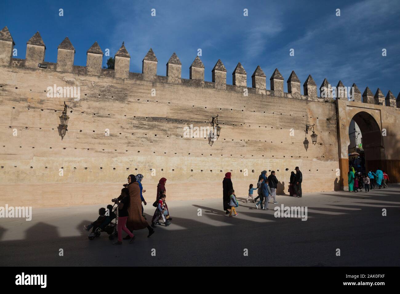 Fußverkehr in Nachmittag Landschaft der Erde gerammt Stadtmauern mit Marktlücken und Zinnen im Bereich der Bab Mechouar und Bab Dekkakin in Fes (fès), Marokko Stockfoto