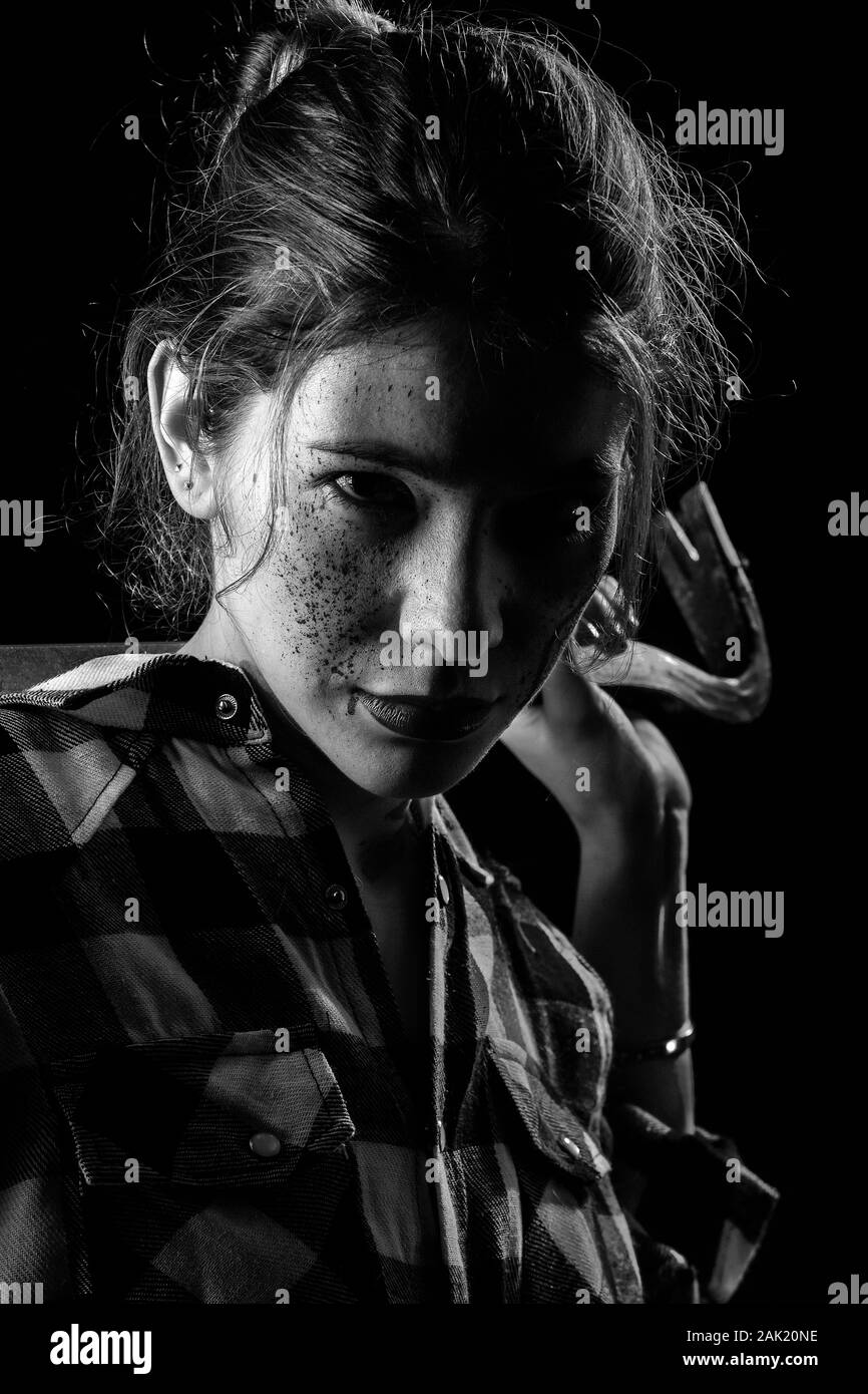 Blutiger ernst junge Frau mit Brecheisen in dunklen Blick auf Kamera monochromen Bild Stockfoto
