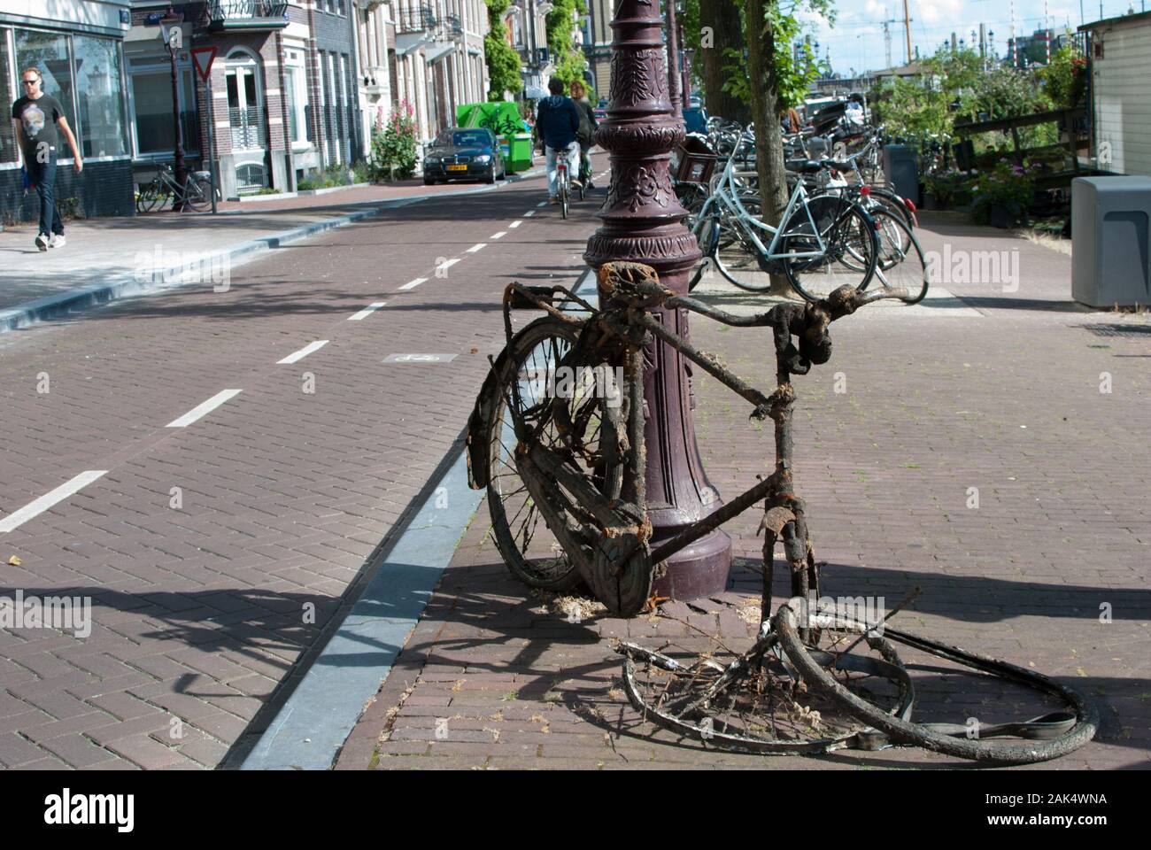Altes Fahrrad wird mitten auf der Straße verrostet Stockfoto