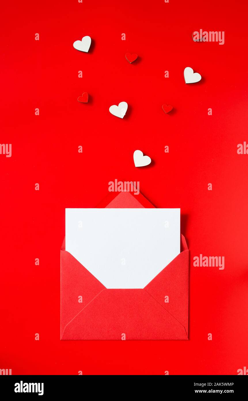 Valentinstag Grusskarten. Roter Umschlag mit eine leere Karte. Mockup der Liebesbrief. Ansicht von oben mit Platz für ihre Grüße. Flach Stockfoto