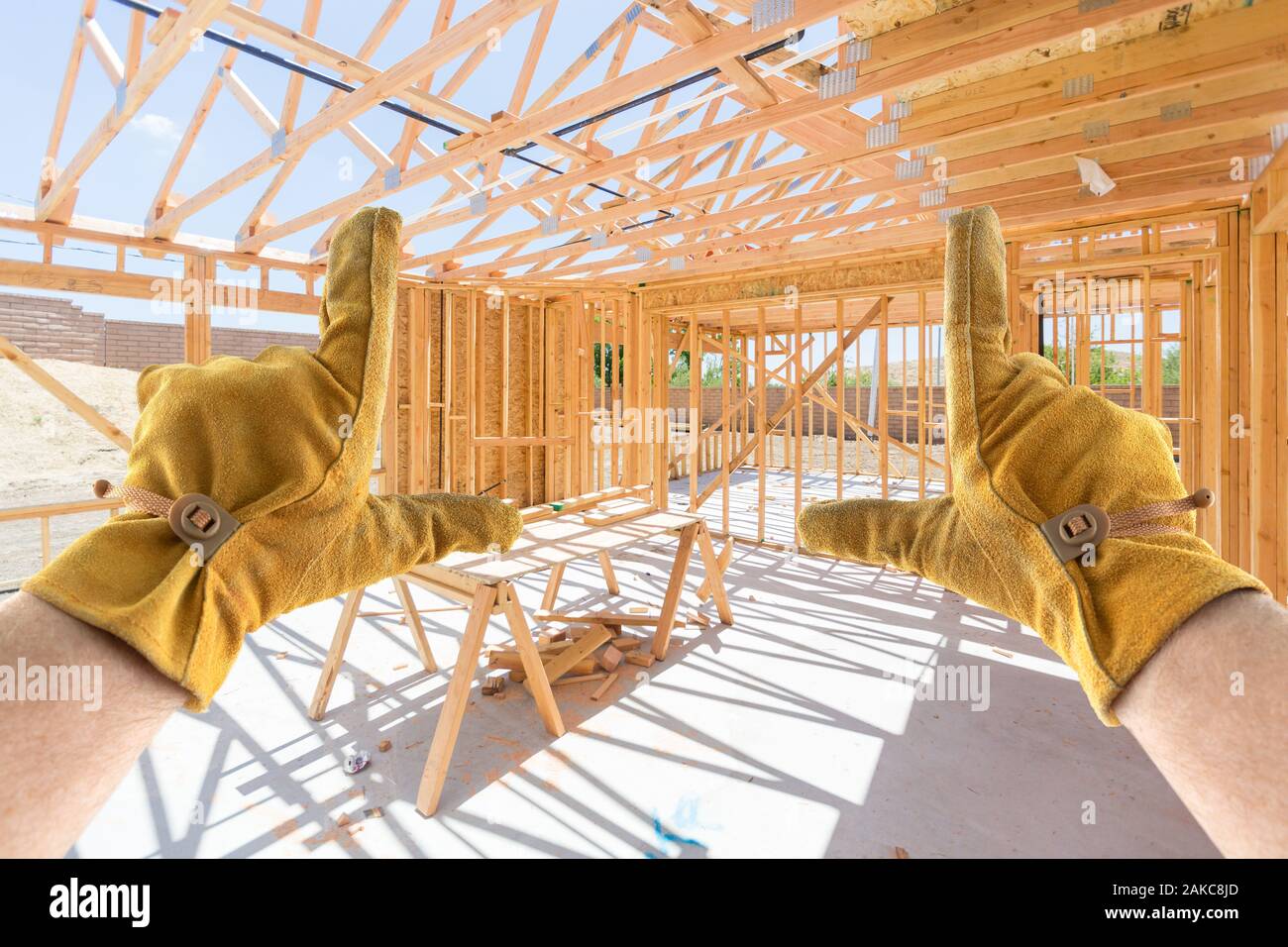 Männliche Auftragnehmer Hände Framing unfertige Haus Framing auf der Baustelle Stockfoto