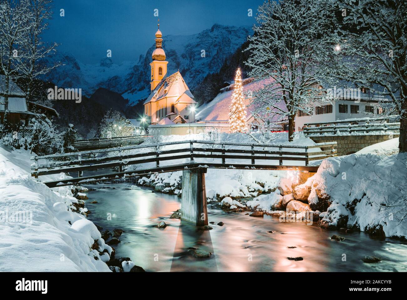 Schöne Dämmerung Blick auf Sankt Sebastian Wallfahrtskirche mit geschmückten Weihnachtsbaum während der Blauen Stunde leuchtet in der Dämmerung im Winter, Ramsau, Nat Stockfoto