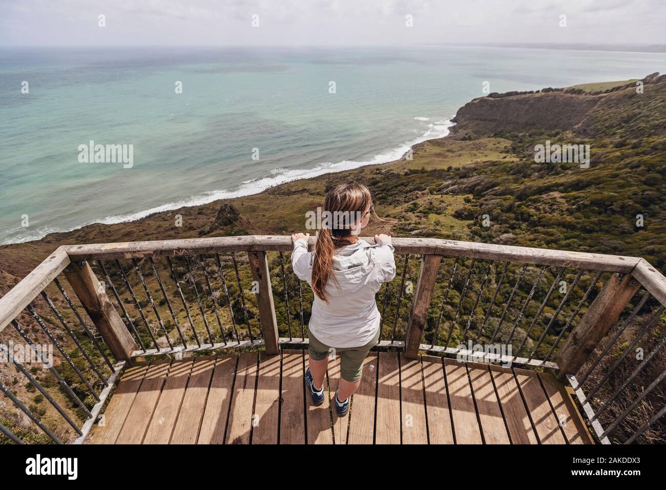 Weibchen schaut aus dem Hochblick auf das Meer, Raglan, Neuseeland Stockfoto