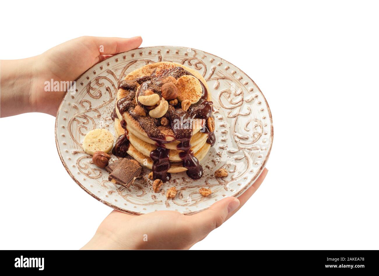 Stapel von heißen Pfannkuchen in der Frau die Hände. Isoliert. Stockfoto