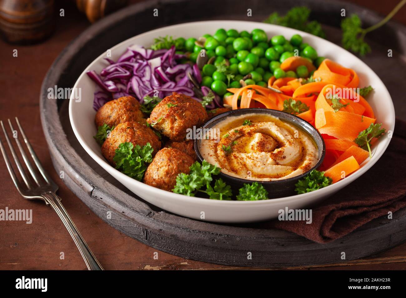 Gesund vegan Mittagessen Schüssel mit falafel hummus Karotte Bänder Kohl und Erbsen Stockfoto