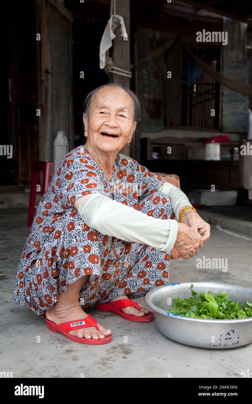 Ältere asiatische Frauen bereiten den Salat in traditionellen Quietschen vor Stockfoto