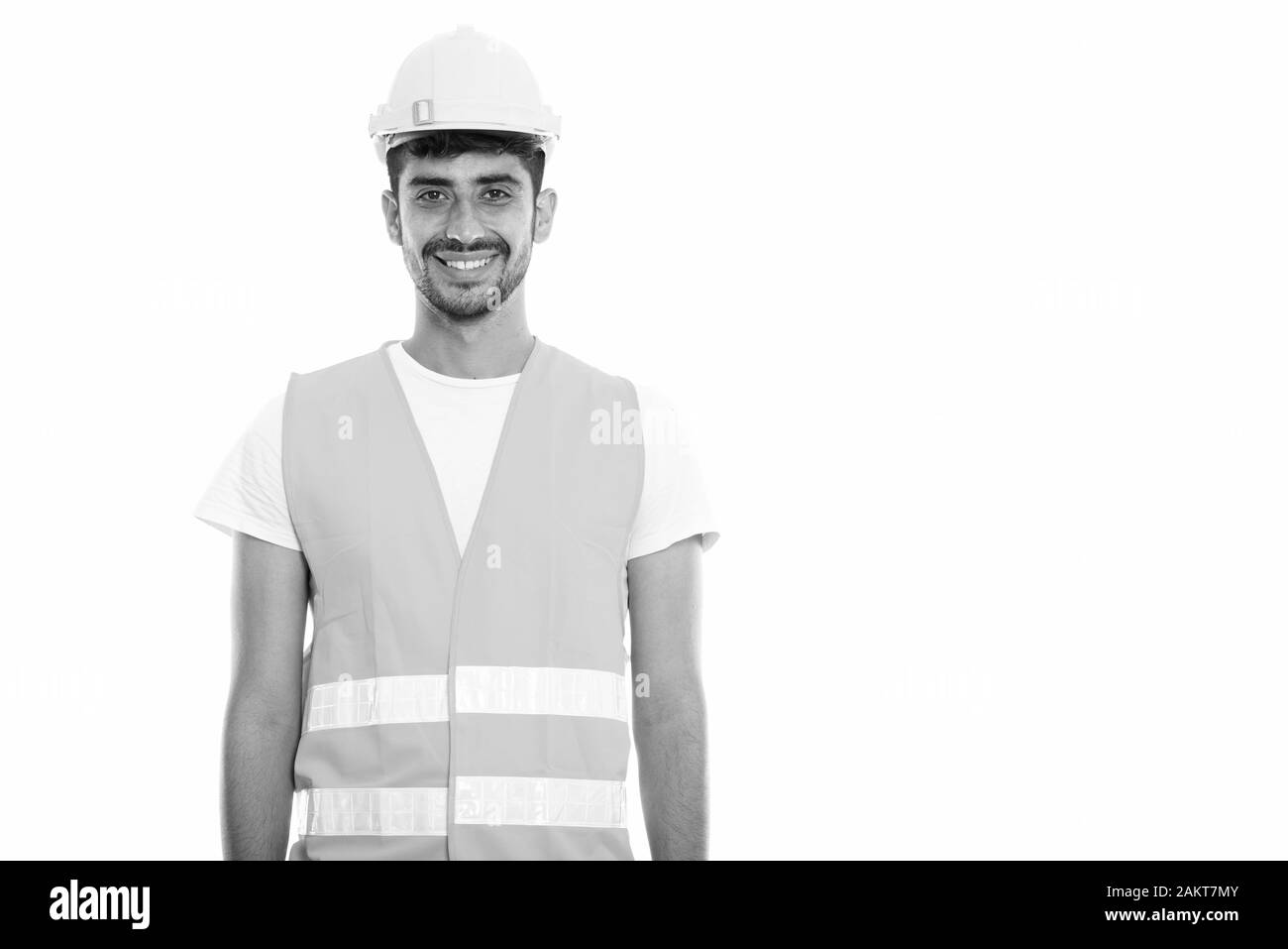 Studio shot der Jungen glücklich Persischen mann Bauarbeiter lächelnd Stockfoto