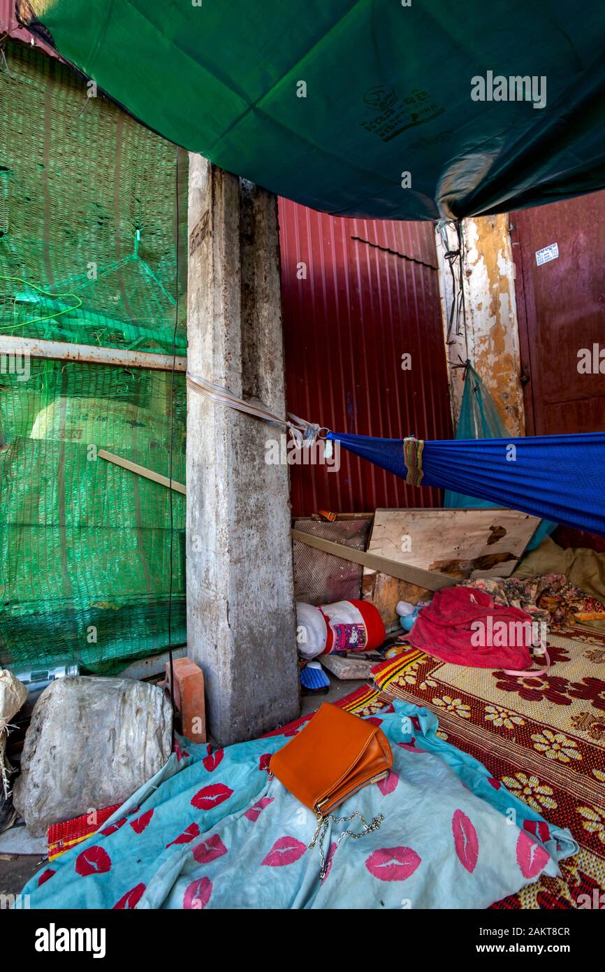 Schlafmatten auf einer harten Zement Bürgersteig erleichtern die Unannehmlichkeit der Schlaf für die armen Obdachlosen Aasfresser auf einem Bürgersteig in Kampong Cham, Kambodscha. Stockfoto