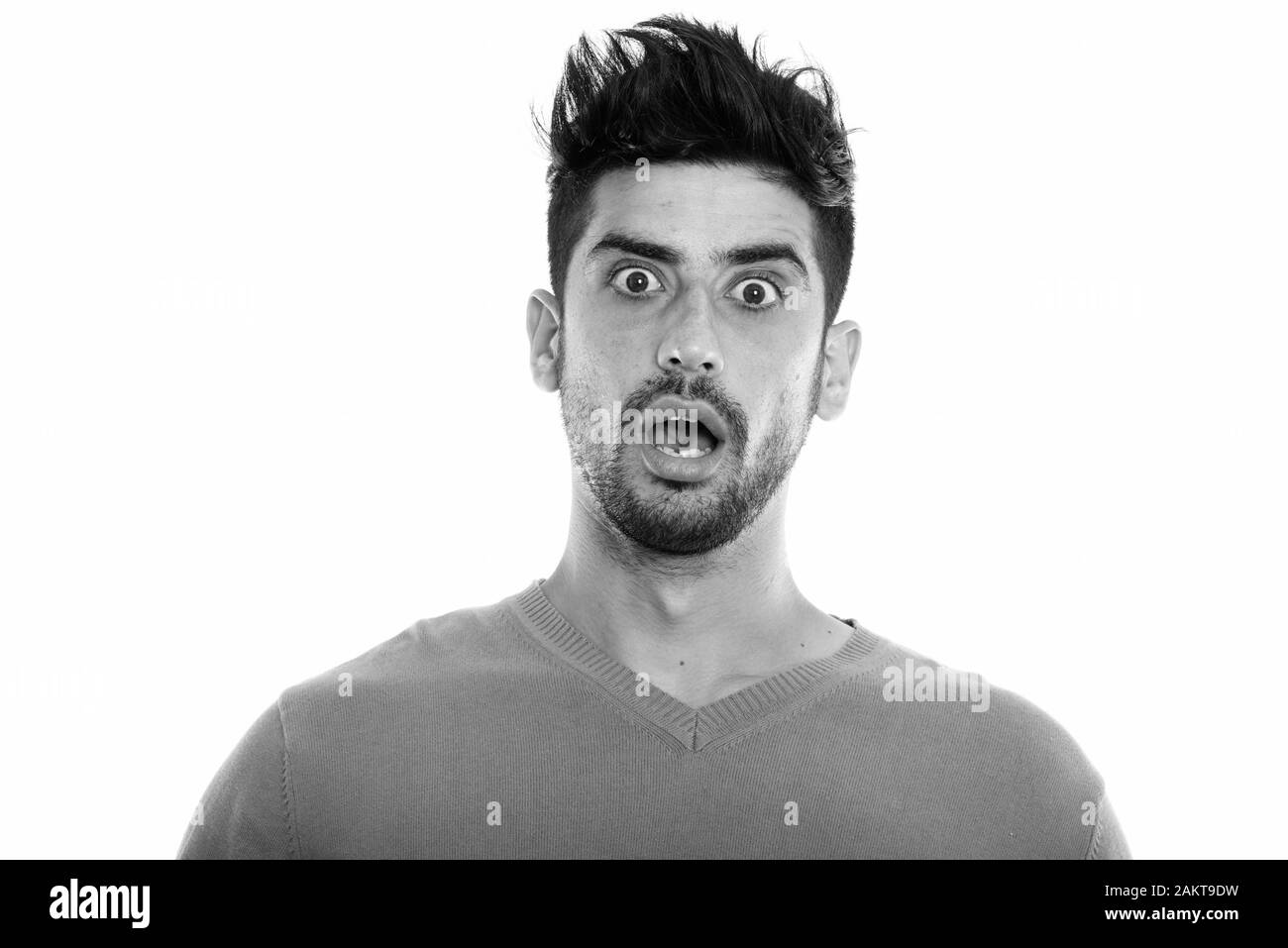 Studio shot der jungen Persischen Mann schockiert mit Mund Suche öffnen Stockfoto