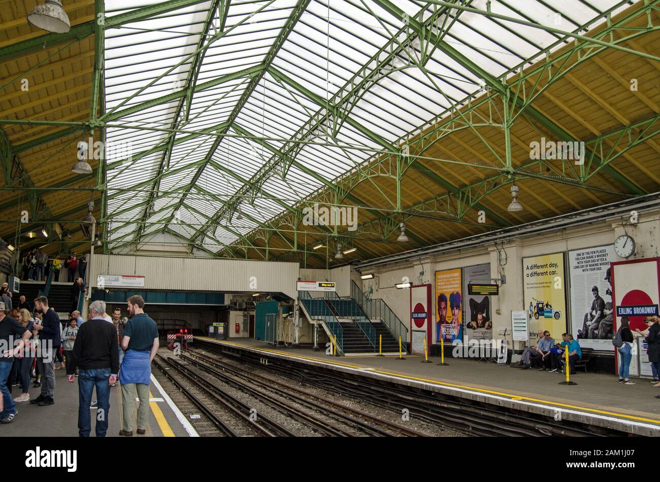 London, Großbritannien - 22. Juni 2019: Passagiere auf dem Bahnsteig für Züge der District Line im historischen edwardianischen Teil der Ealing Broadway Station in West Lond Stockfoto