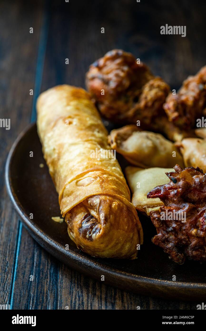 Frühlingsrollen mit Samosas/Samsa mit Huhn Pakora und Aloo Tikki. Traditionelle Speisen. Stockfoto