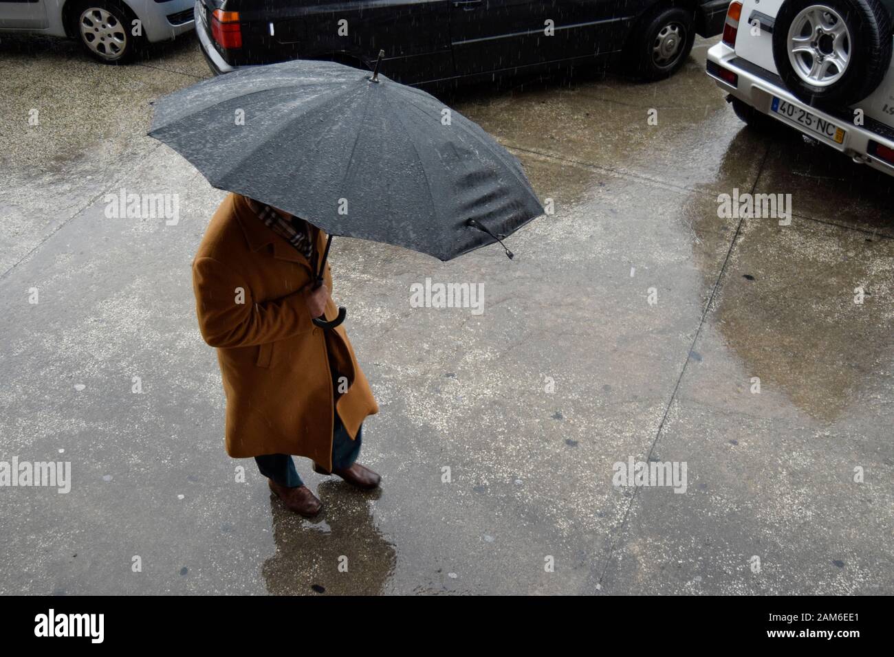 Fußgänger versuchen, sich bei starkem Regen in Coimbra Portugal trocken zu halten Stockfoto