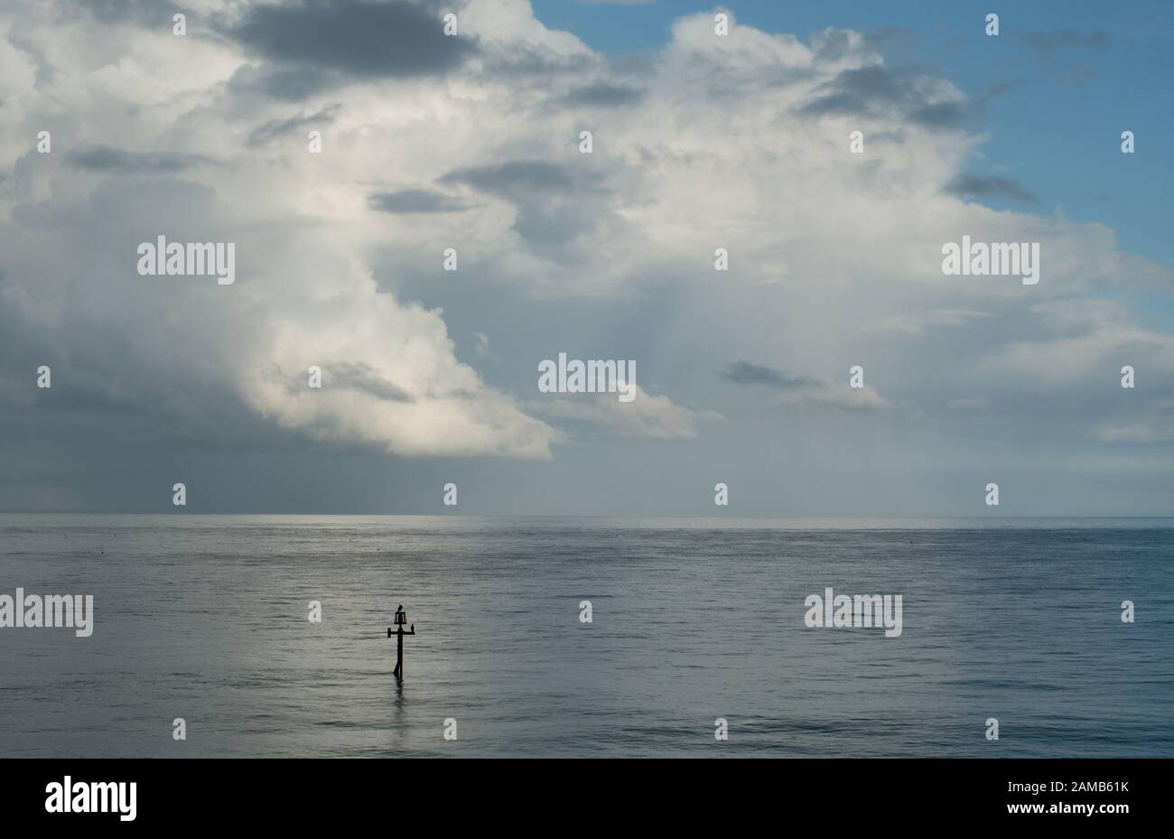 Ein minimalistisches, friedliches Bild von Meer, Horizont, Wolke und blauem Himmel vor der Norfolkküste, das in angenehmem Licht gefangen ist Stockfoto