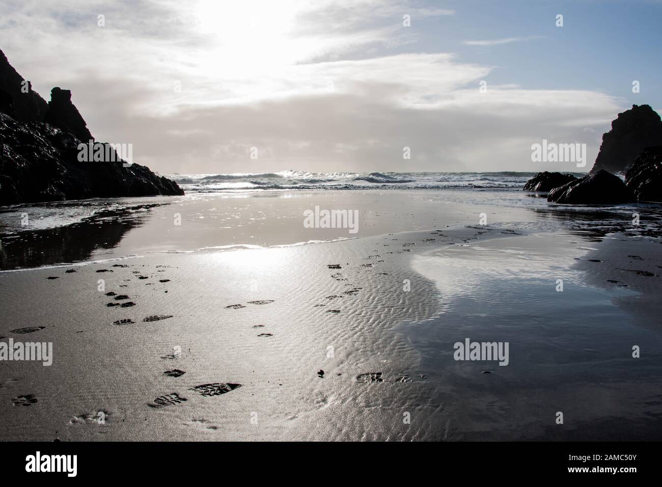 Fußabdrücke am Strand in Richtung Meer in Kynance Cove, Cornwall Stockfoto