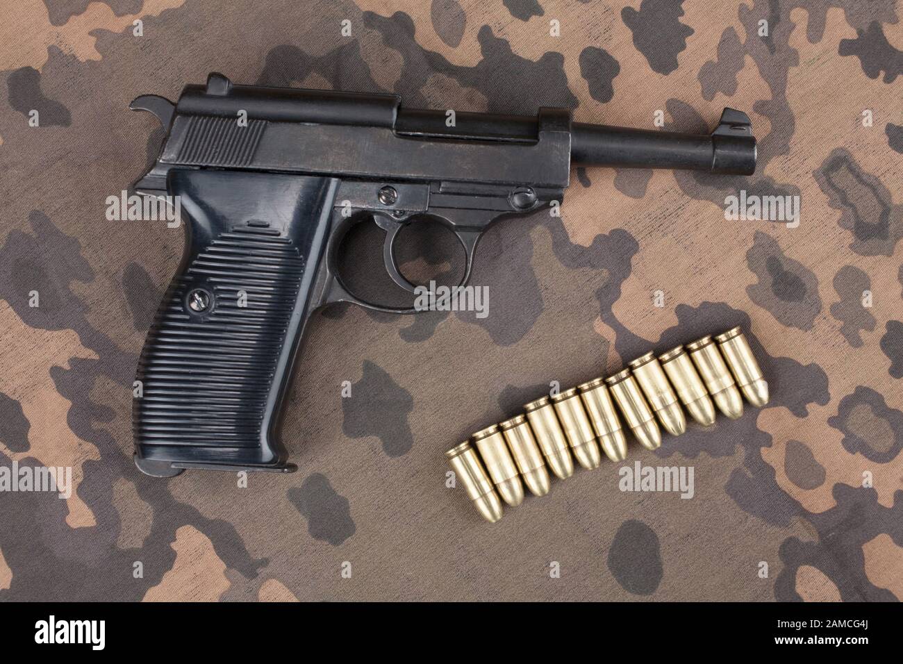 WWII ära Nazi-deutschen Armee 9 mm halbautomatische Pistole mit Munition auf getarnte einheitlichen Hintergrund Stockfoto