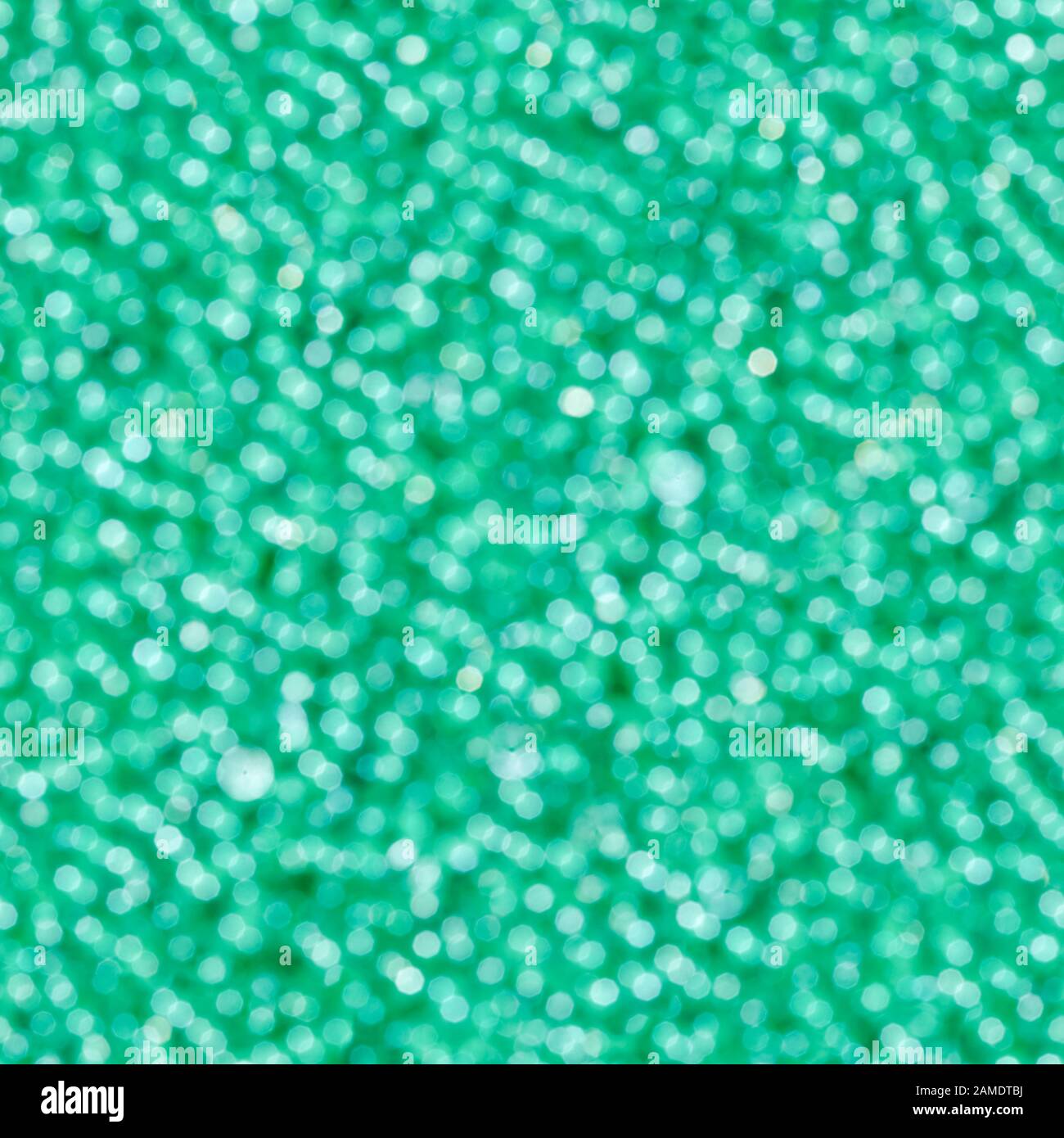Abstraktes grünes Licht bokeh. Unschärfem Hintergrund. Nahtlose quadratische Textur. Stockfoto
