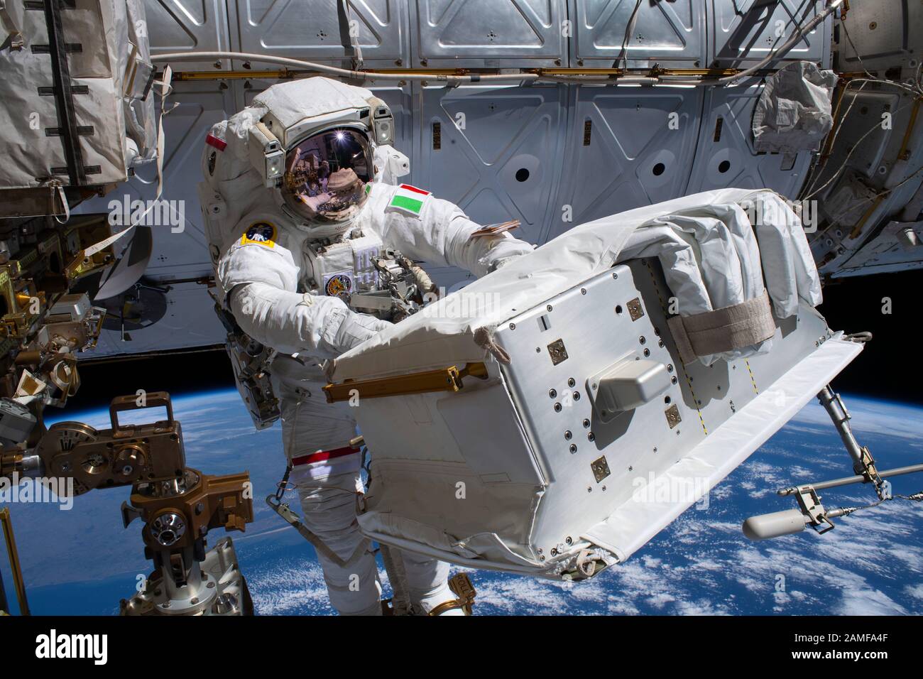 ISS - 2. Dezember 2019 - der ESA-Astronaut Luca Parmitano, der am Canadarm2-Roboterarm befestigt ist, trägt das neue Wärmepumpensystem TH Stockfoto