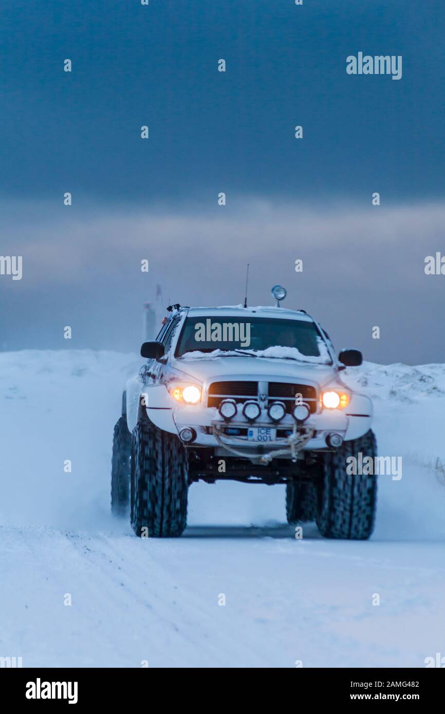 SUV fahren entlang der Straße im Schnee in Island im Januar Stockfoto