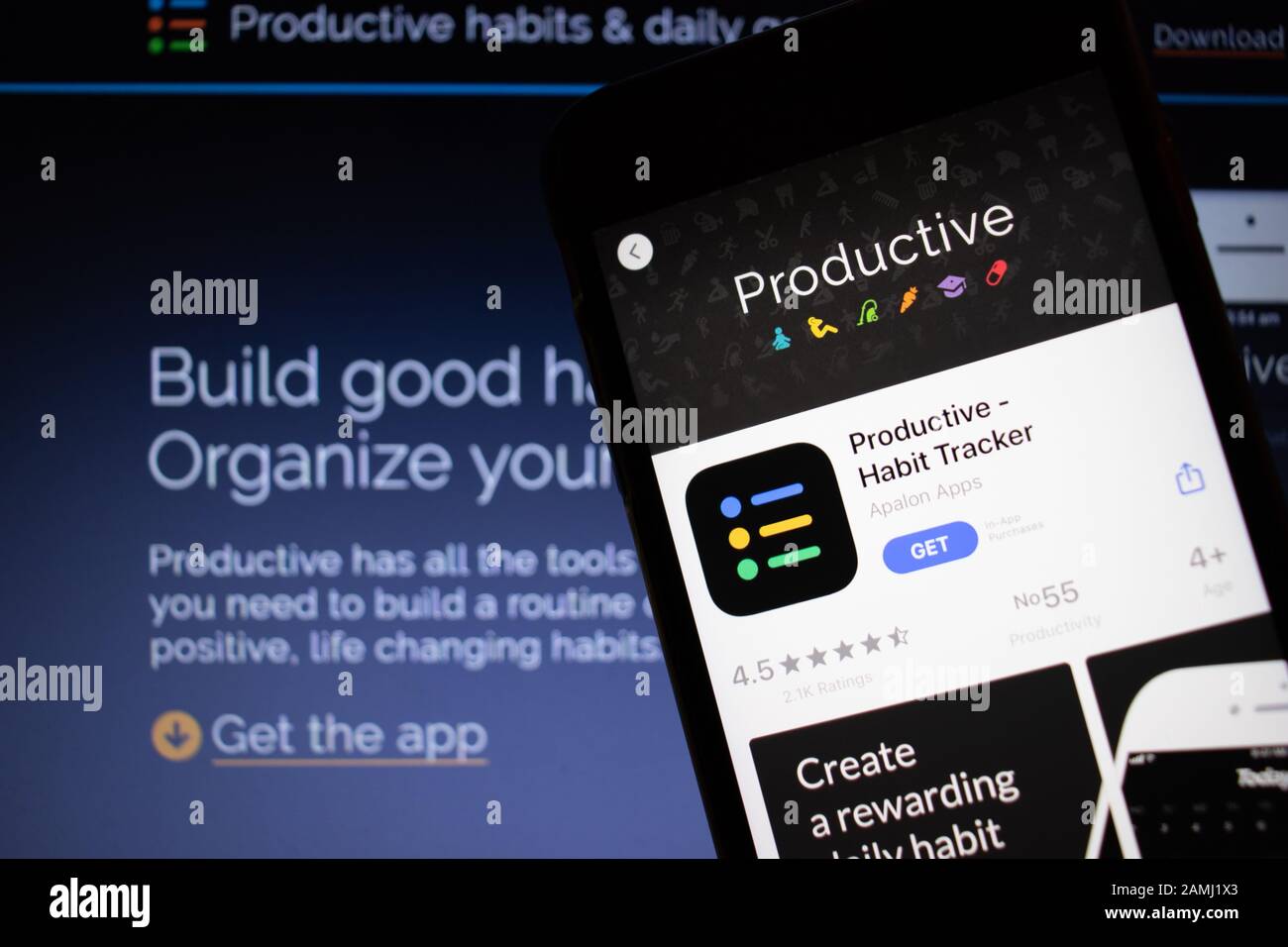 Sankt Petersburg, Russland - 10. Januar 2020: Mobiltelefon mit Produktiv - Habit Tracker Symbol auf dem Bildschirm Nahaufnahme mit Website auf Laptop, Illustrativ Stockfoto