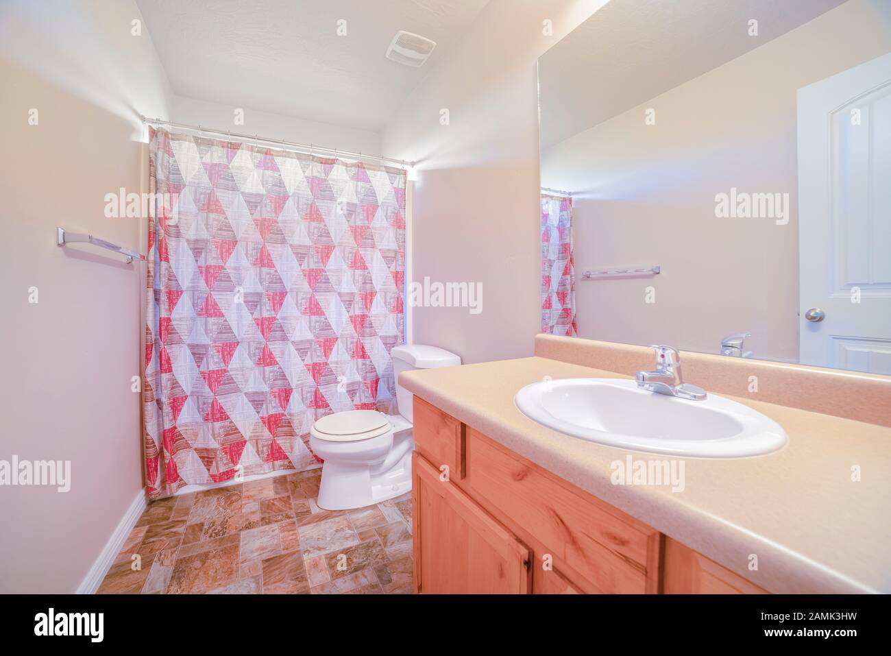 Gepflegtes, sauberes Badezimmer mit geschlossenem Duschvorhang Stockfoto