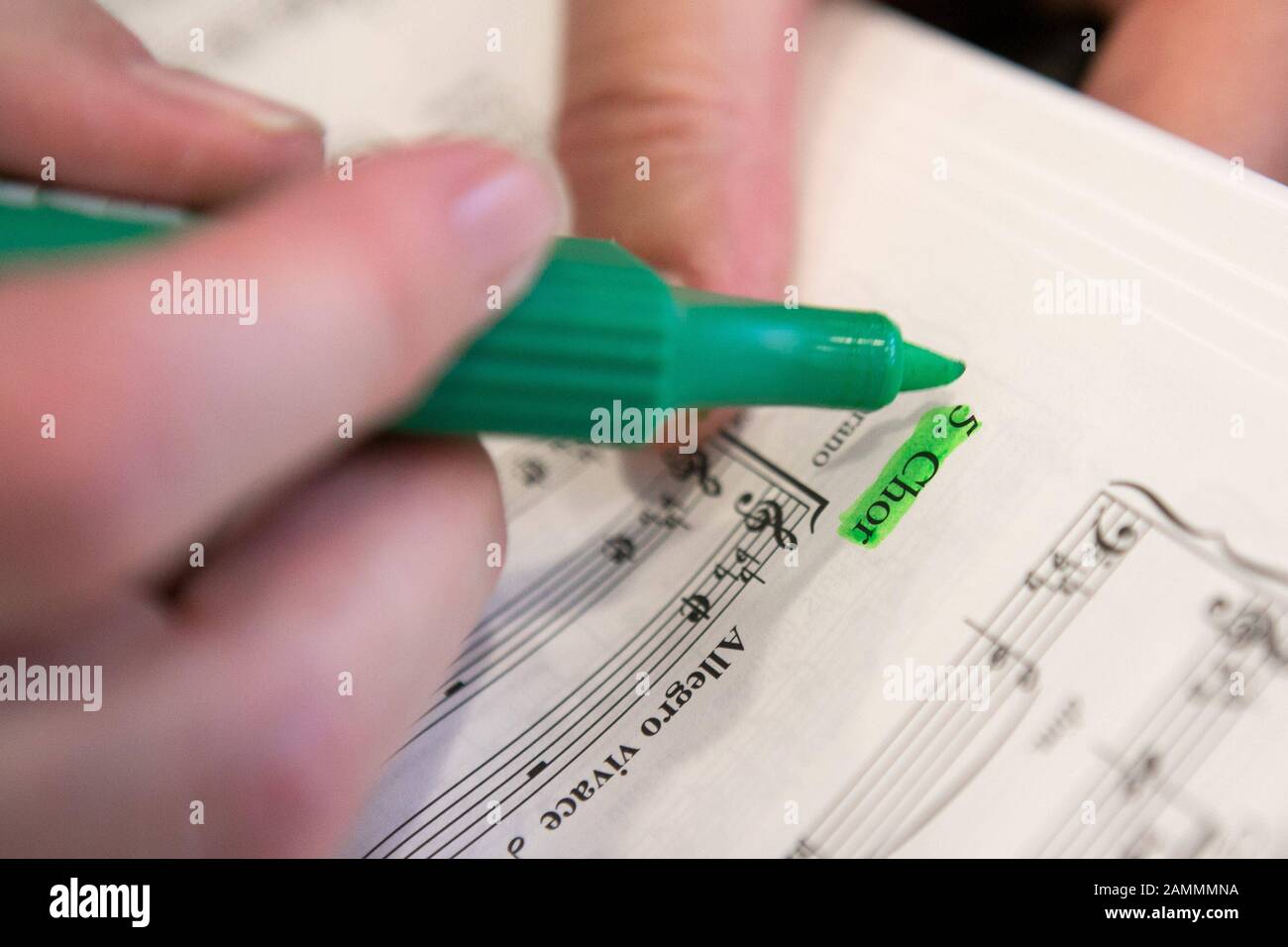 Chorprobe des Elias-Oratoriums in Pasing. Eine Chorsängerin macht in ihrem Notenblatt Markierungen. [Automatisierte Übersetzung] Stockfoto
