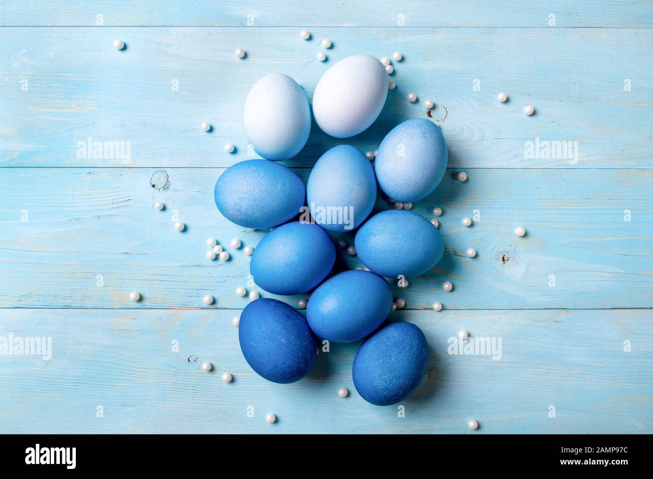 Osterkonzept. Ombre Eier in blauen Farben auf blauem Holzhintergrund mit Platz für Text. Draufsicht oder flache Lage. Klassische blaue Farben in Ostern 2020 Stockfoto