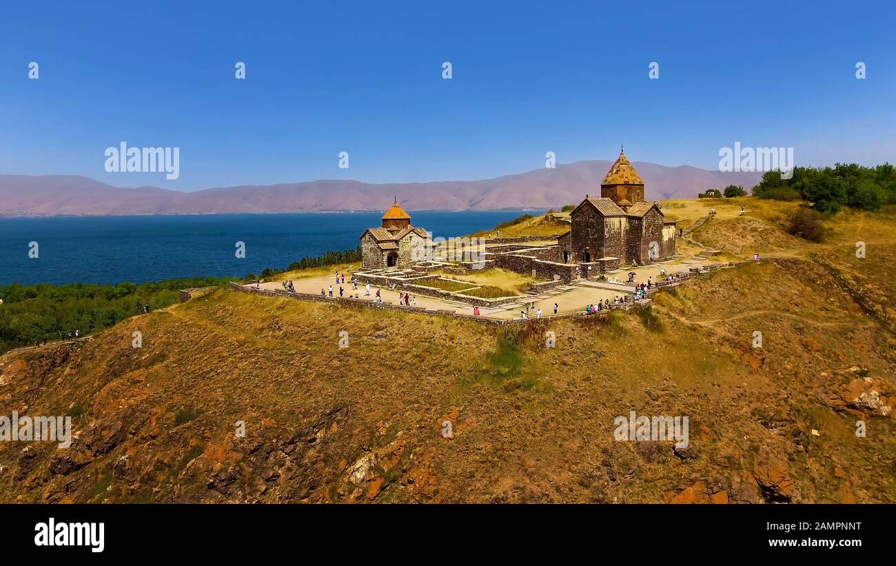 Touristen, die in der Nähe der alten Kirchen Surp Arakelots und Astvatsatsin, Armenien, spazieren gehen Stockfoto