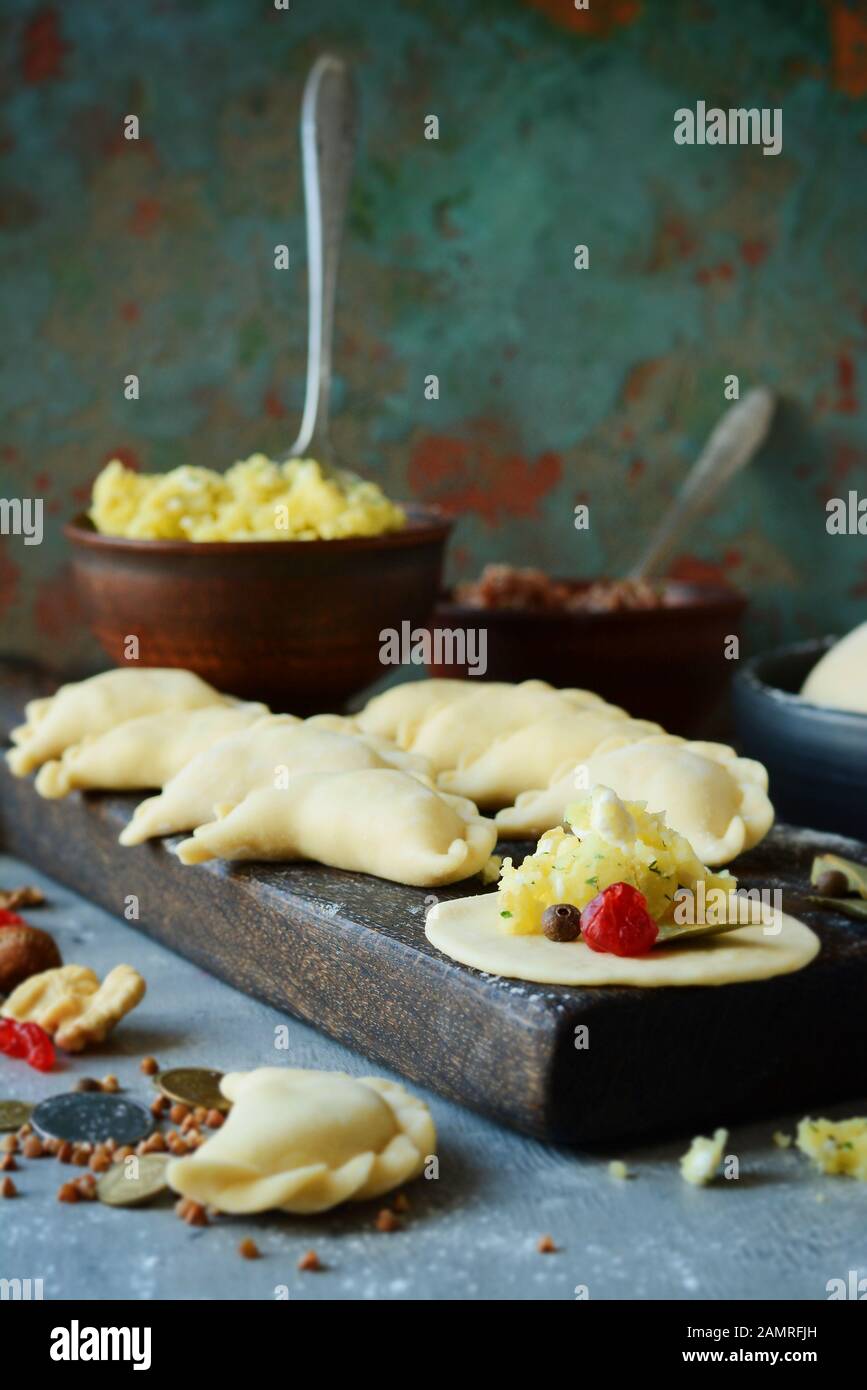 Knödel mit Kartoffeln mit Kräutern auf einem blauen Hintergrund. Wareniki, vareniki, Pierogi, pyrohy-Knödel mit Füllung. Stockfoto