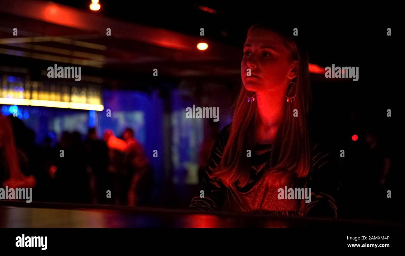 Attraktives Mädchen, das Getränke bestellt, Entspannung im Nachtclub, Studentenleben am Wochenende Stockfoto