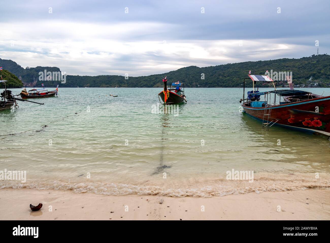 Traditionelle hölzerne Longtail Boote an einem Strand in Phi Phi Island geparkt. Klares Wasser und sauberen Strand. Stockfoto