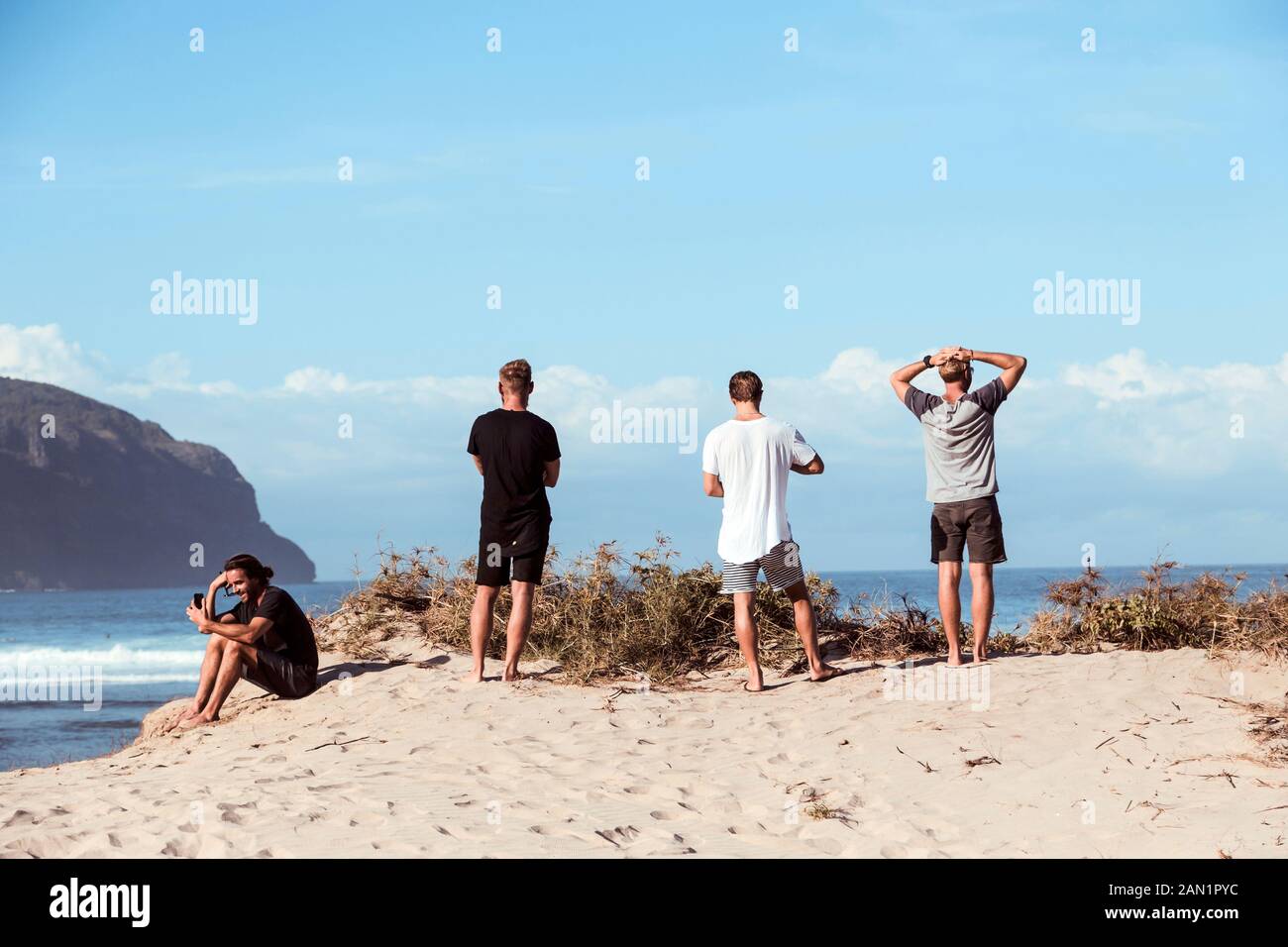 Junge Leute am Strand bei sonnigem Tag Stockfoto