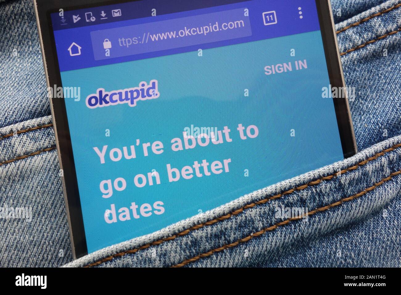 Okcupid Website angezeigt auf dem Smartphone in Jeans Tasche versteckt Stockfoto