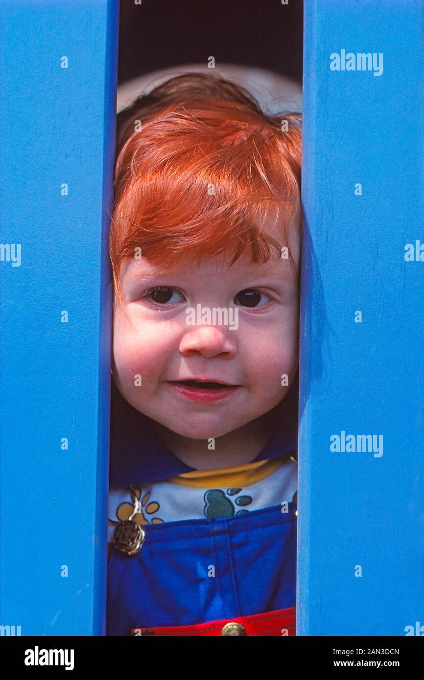 Junge Kind mit roten Haaren auf einem Spielplatz Stockfoto