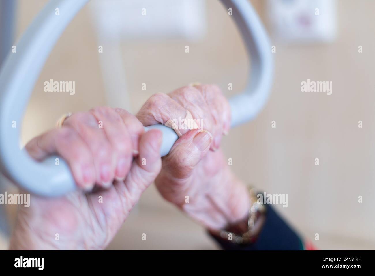 15. Januar 2020, Baden-Württemberg, Böblingen: ein Bewohner des Pflegeheims hält an zu einem dreieckigen über ihrem Bett mit ihren Händen. Foto: Tom Weller/dpa Stockfoto