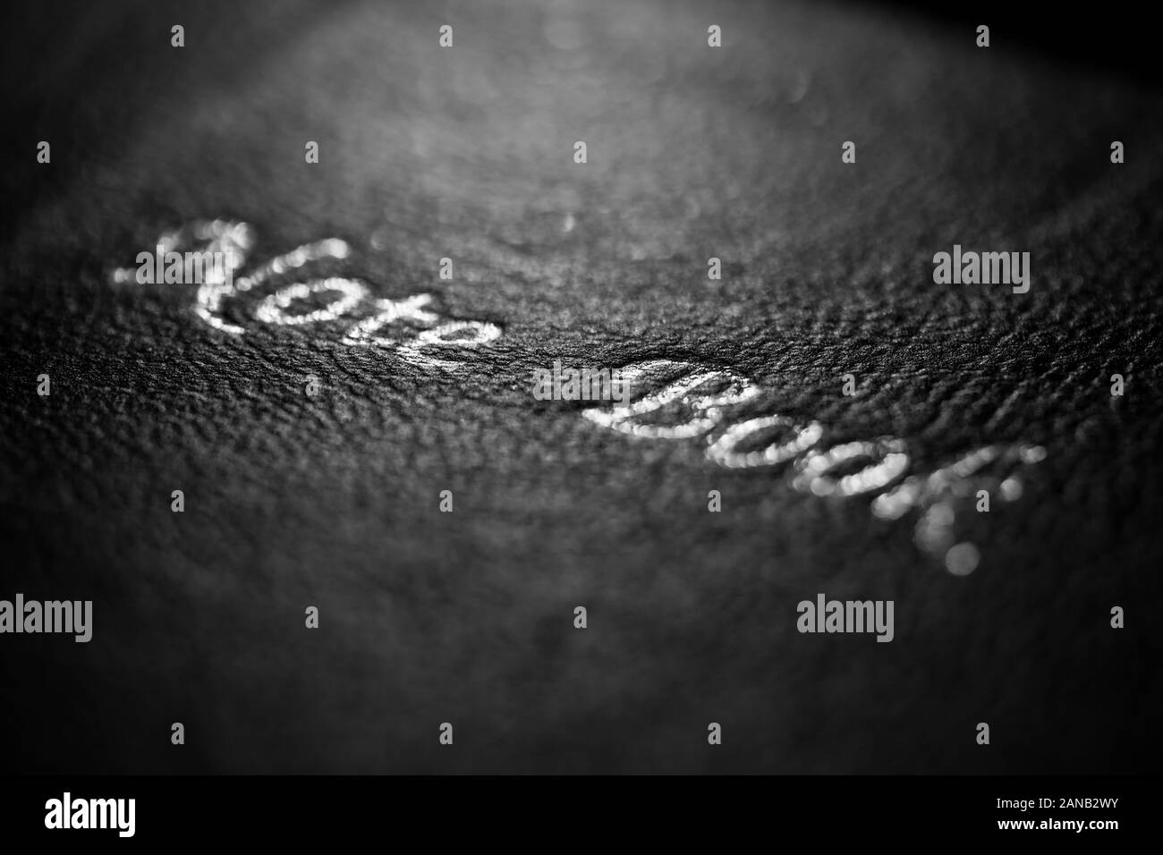 Close-up des Schwarzen lerike Oberfläche eines Buch Cover mit den Worten Hinweis Buch in einem dunklen Erscheinung. Stockfoto
