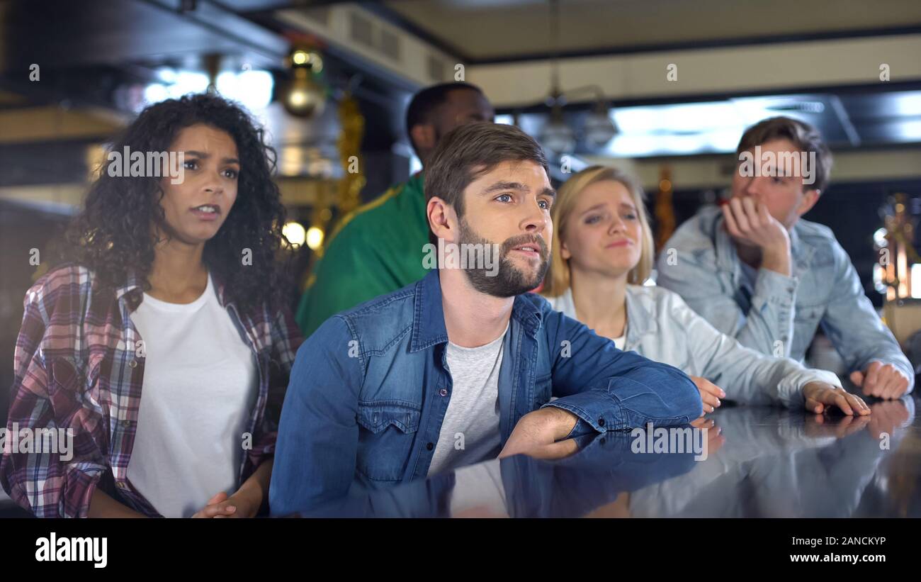 Portugiesische Fans mit National Flagge verärgert über Verlust, Sport Fernsehen in bar Stockfoto