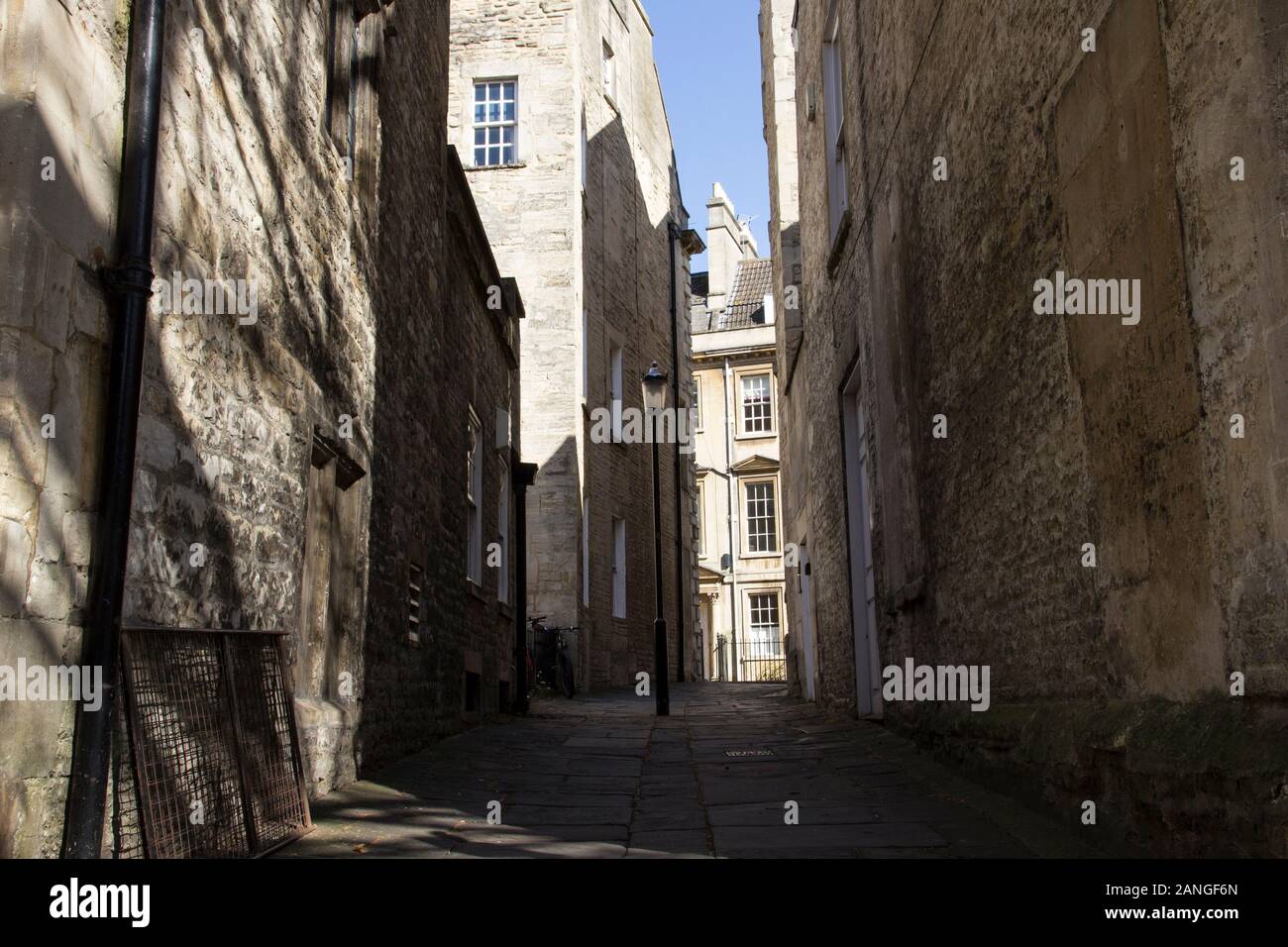 Badewanne, Großbritannien - 10 April, 2019. Lange Schatten auf die Gasse in den Innenhof werfen. Bath, England, UK, 10. April 2019 Stockfoto