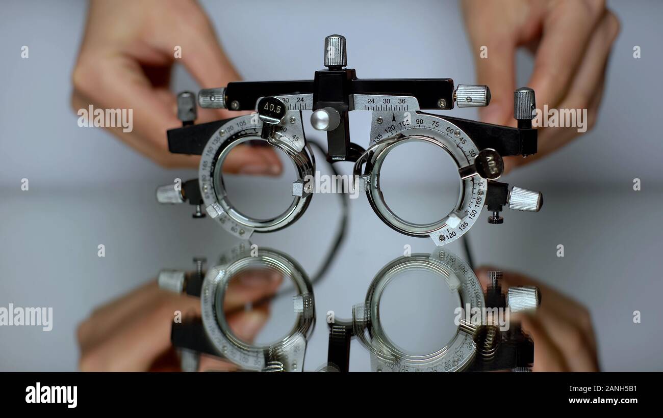 Hände setzen spezielle Brille für Vision prüfen, Diagnose von Augenerkrankungen Stockfoto