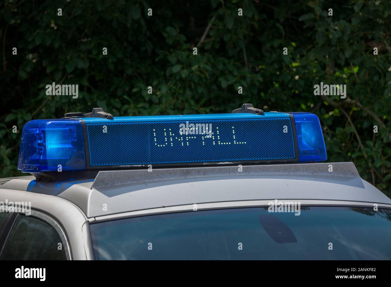 Nahaufnahme einer Dach- oder Bar auf dem Dach auf einem Polizeiauto mit der Inschrift in deutscher Sprache, der Unfall Unfall bedeutet Stockfoto