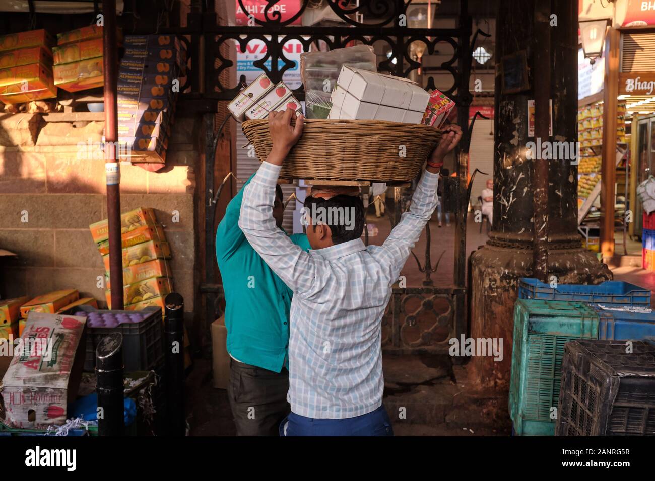 Träger mit ihren Körben Crawford Market oder Mahatma Jyotiba Phule Market, ein wegweisender Obst- und Gemüsemarkt aus der Kolonialzeit in Mumbai, Indien Stockfoto