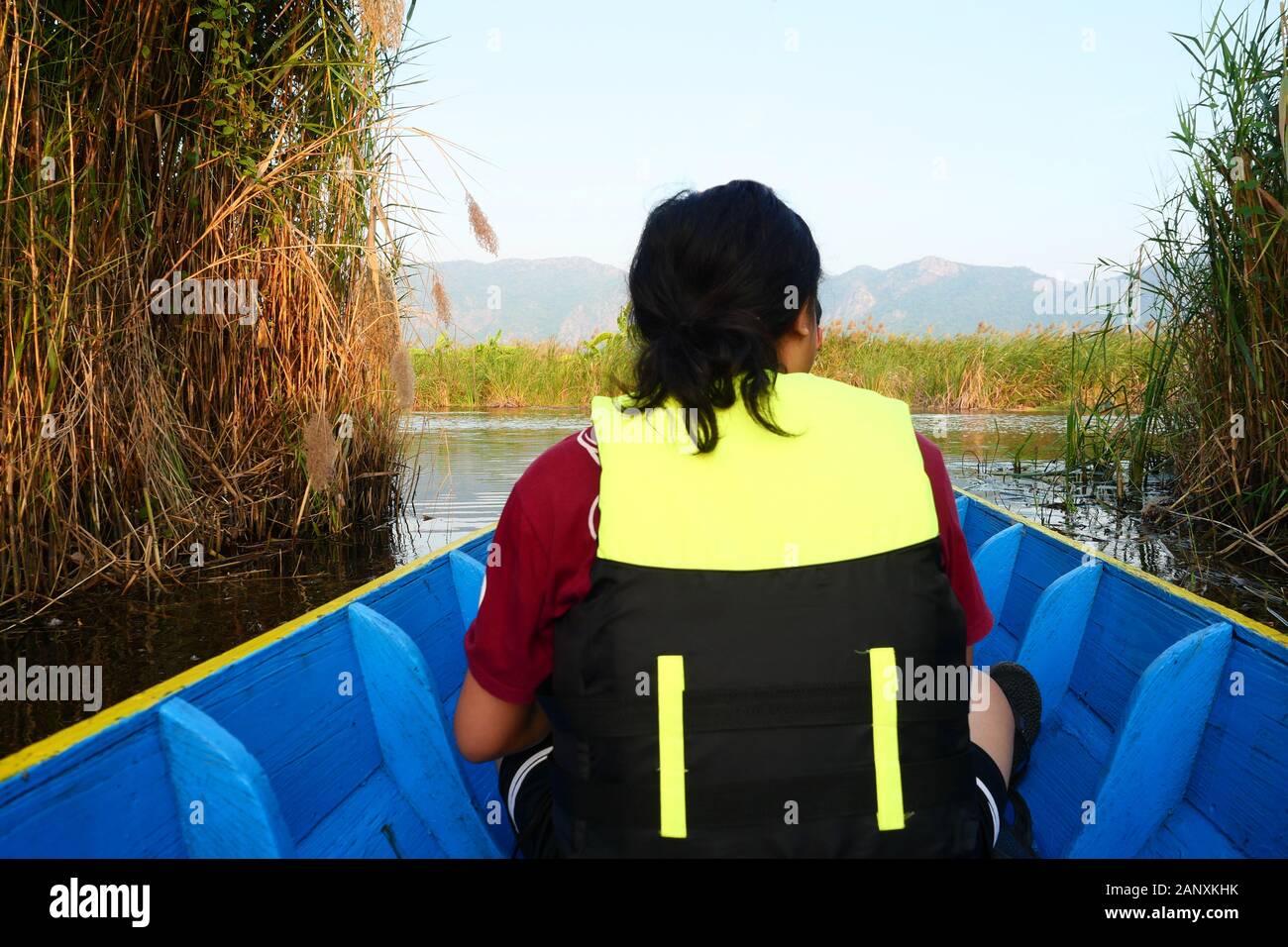 Ein asiatischer Mann das Tragen einer Schwimmweste in einem Boot sitzen, Thai Taxi Boote mit Personal Flotation Gerät, wurde das Schiff in See Stockfoto