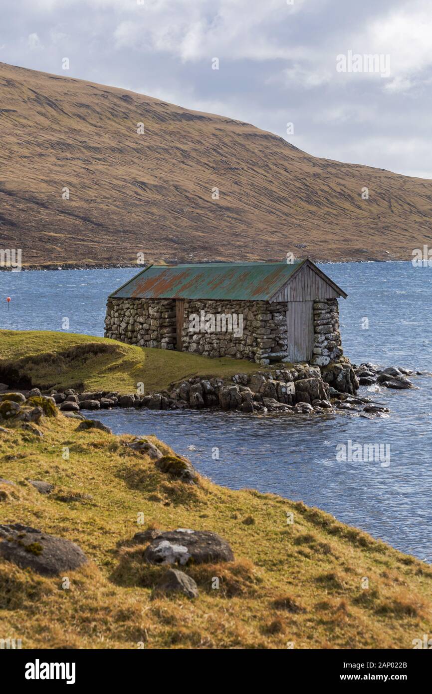 Stein Bootshaus mit Wellblechdach, Leitisvatn Sørvágsvatn, Vagar, Färöer, Dänemark im April - Färöer Leitisvatn Sorvagsvatn Stockfoto