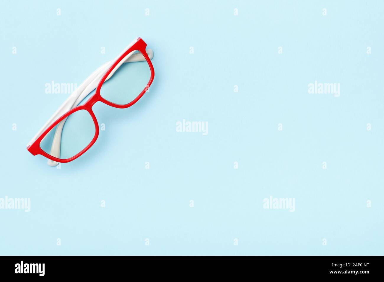 Moderne trendige Brillen in rot Frames auf einem blauen Hintergrund. Kopieren Sie Platz. Stockfoto