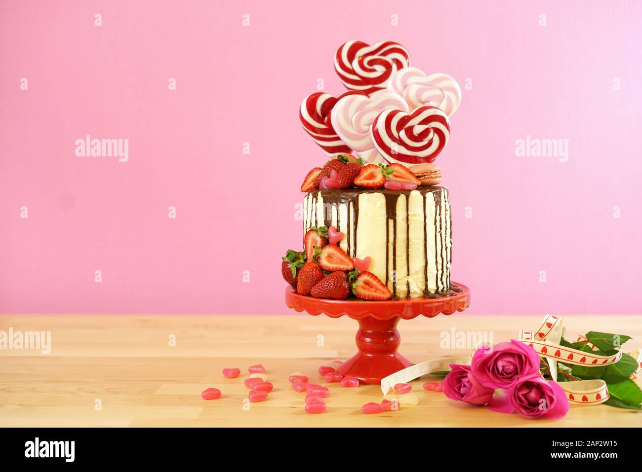 Valentinstag auf - Tendenz candyland Fantasy drip Neuheit Kuchen mit herzförmige Lollis, Candy und frische Erdbeeren dekoriert, mit negativen Cop Stockfoto