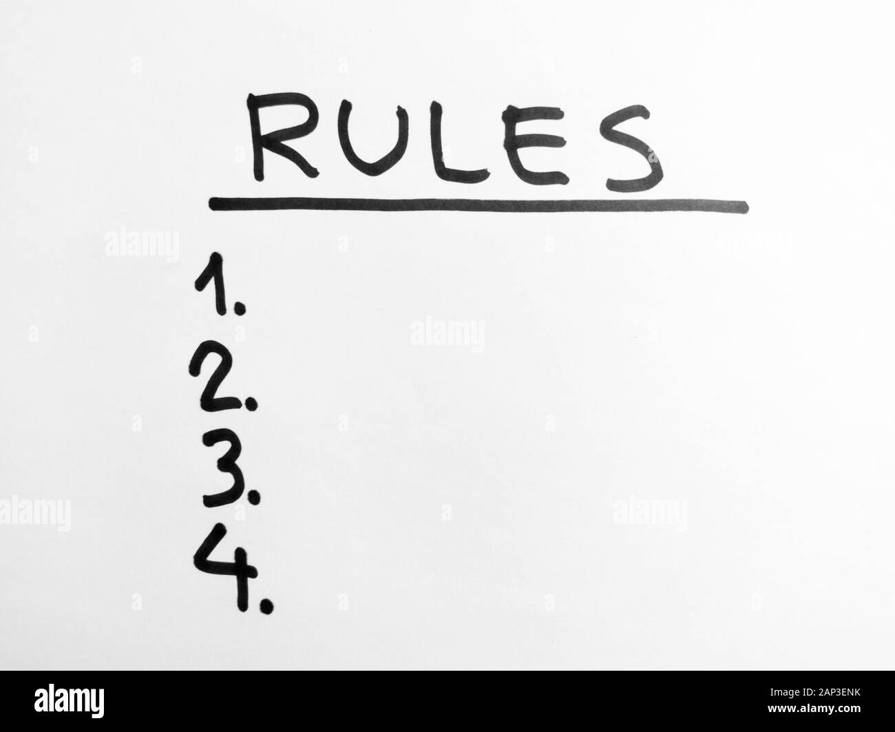 Hand Worte - Regeln - mit schwarzem Marker auf weißem Papier Stockfoto
