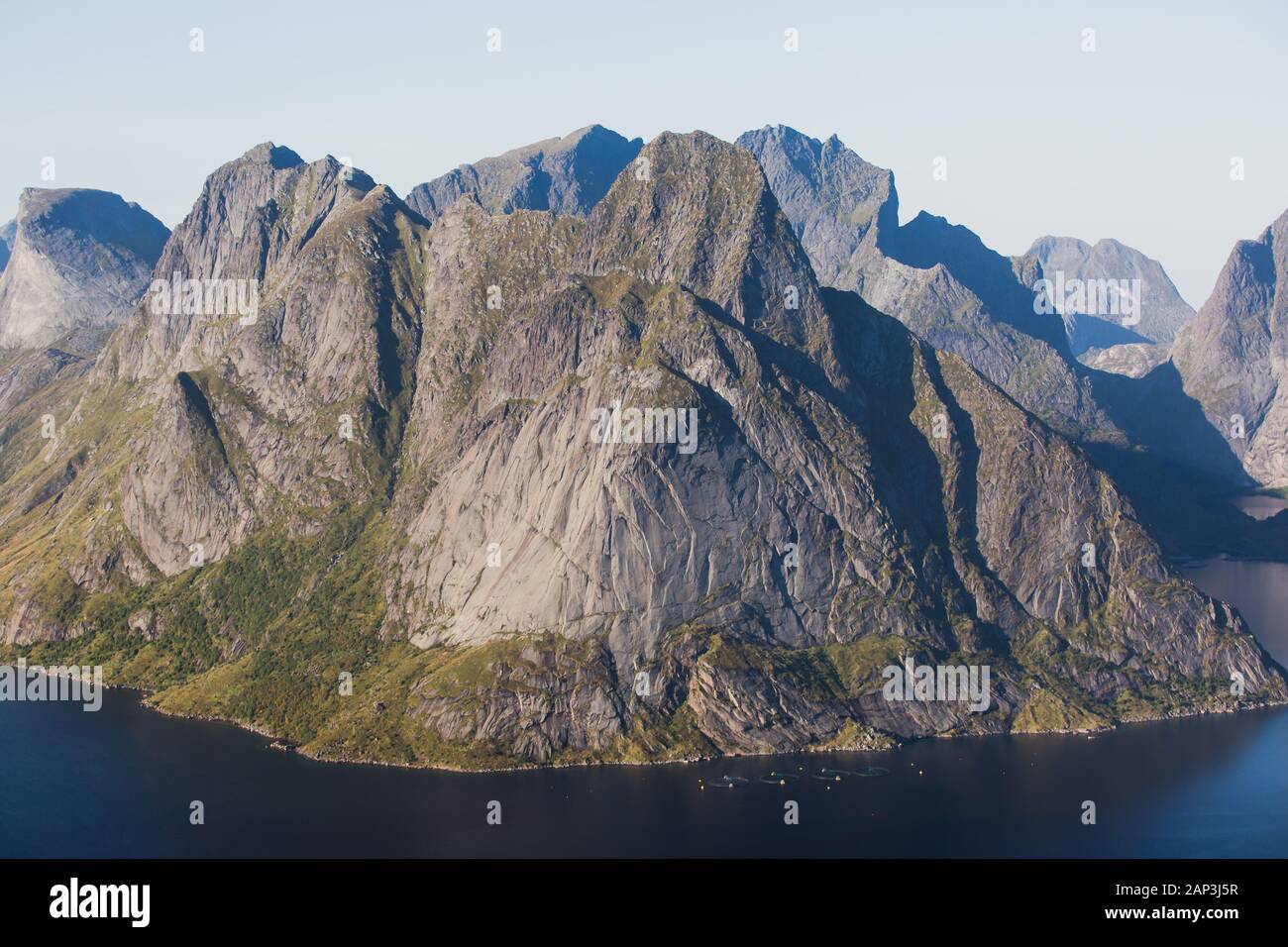 Schöne norwegische Landschaft mit berühmtem Spitzengipfel Reinbringen, Lofoten Inseln, mit einer Gruppe von Wanderern Touristen und mit Blick auf die berühmte Stadt Reine Stockfoto