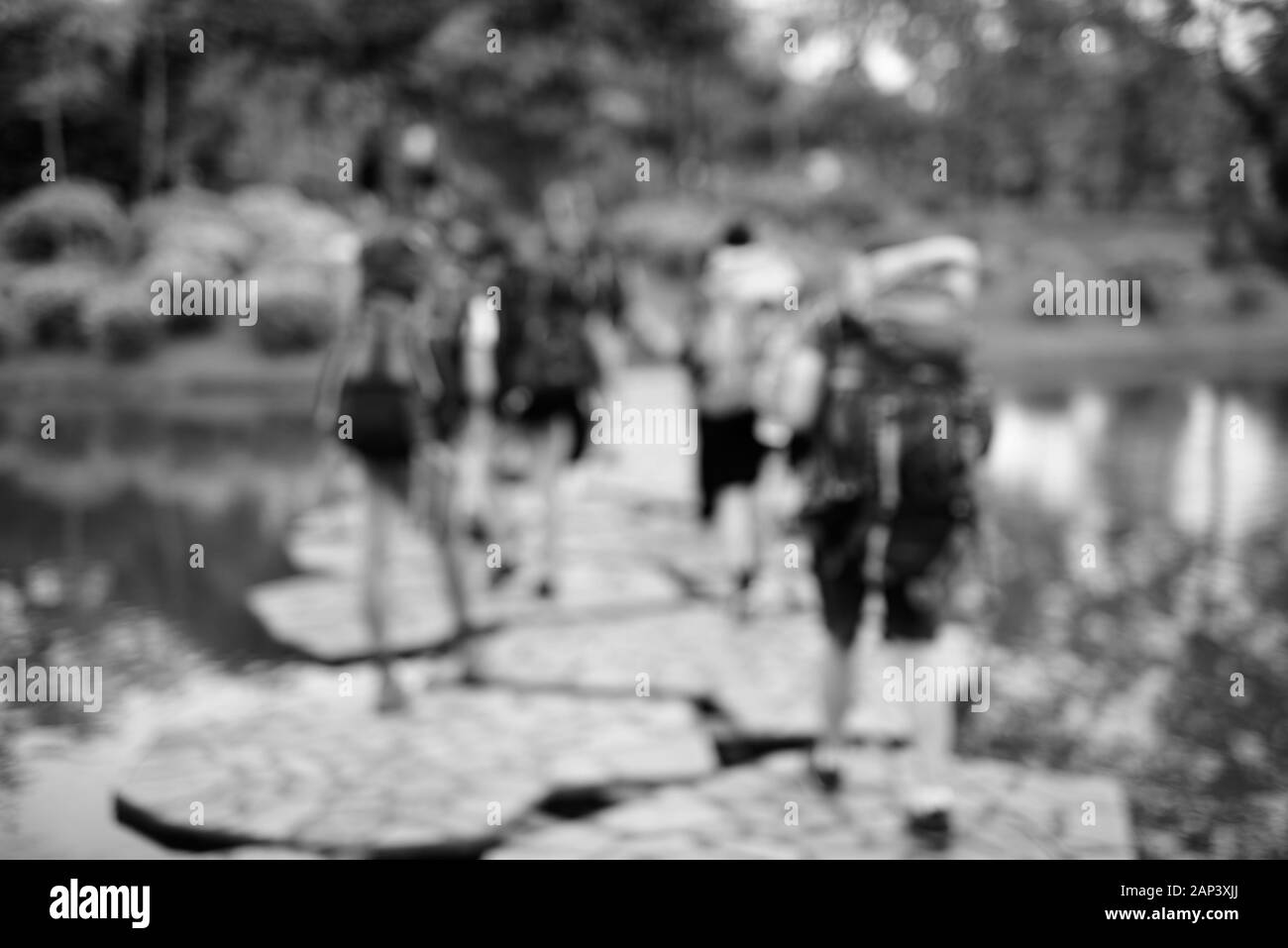 Verschwommen touristische Backpackers überqueren den See im Park Stockfoto