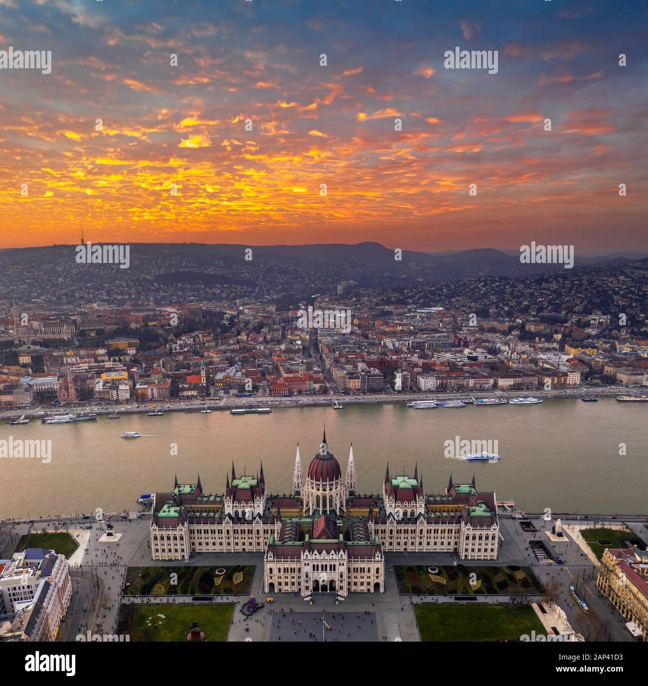 Budapest, Ungarn - Panorama-Dronenblick auf das Parlament Ungarns bei Sonnenuntergang mit wunderschönen goldenen Wolken, Weihnachtsbaum und Anblick Stockfoto