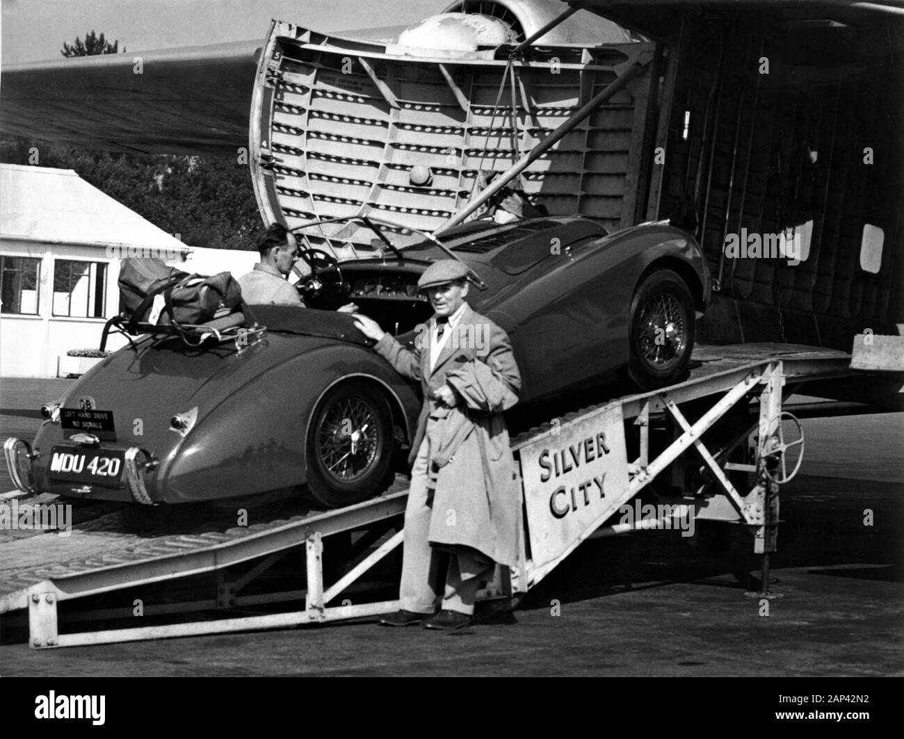 CLARK GABLE im September 1952 mit seiner neuen 1952 Jaguar XK 120 Roadster oben offenen Sportwagen an der silbernen Stadt AIRWAYS in Lympne in Kent, England geladen wird für den Versand in Frankreich auf einem BRISTOL FREIGHTER zweimotorigen Flugzeuge Stockfoto